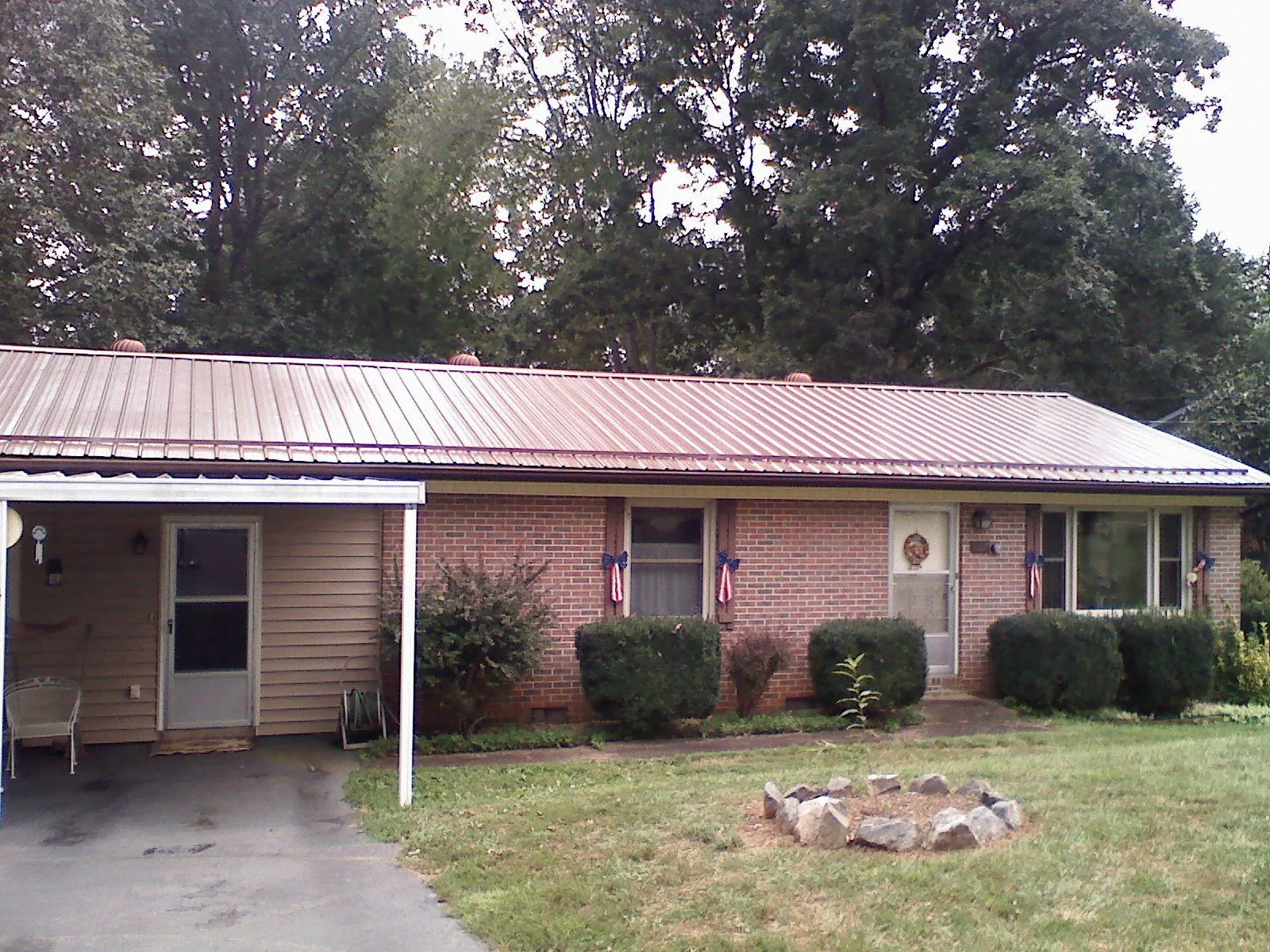 Bronze metal roof and carport on a brick ranch home — Roof Repair work by our crew in Pullman